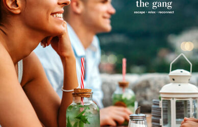 Guests enjoying cocktails on a scenic hotel terrace with mountain views.