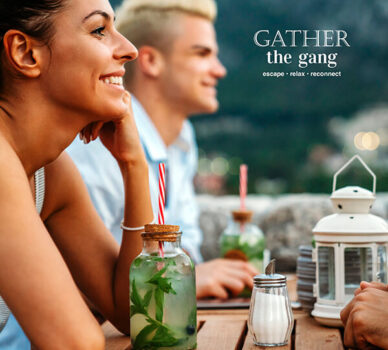 Guests enjoying cocktails on a scenic hotel terrace with mountain views.